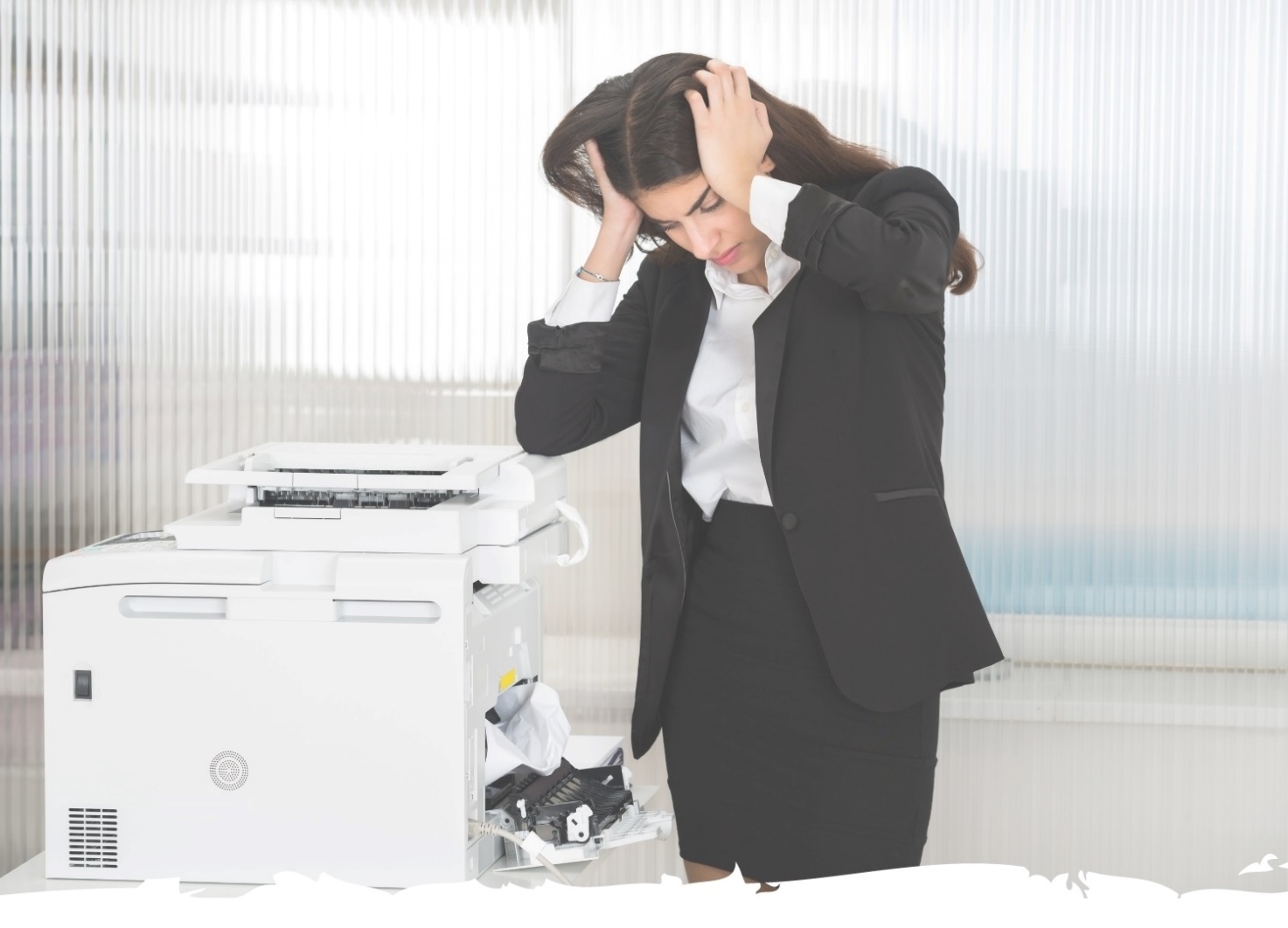 A women holding her head in frustration while looking at a office printer that is jammed.