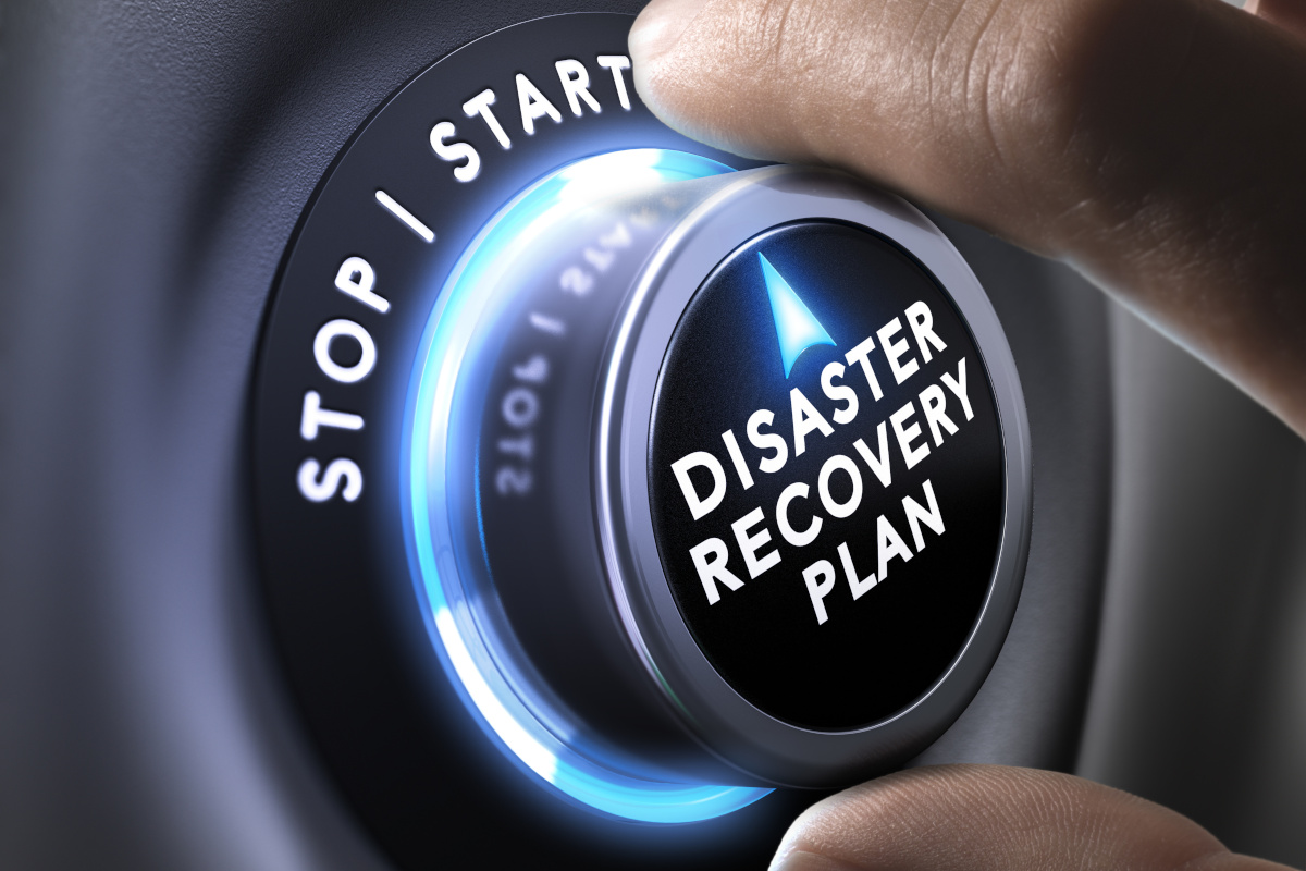 A hand turning a dial for a Disaster Recovery Plan