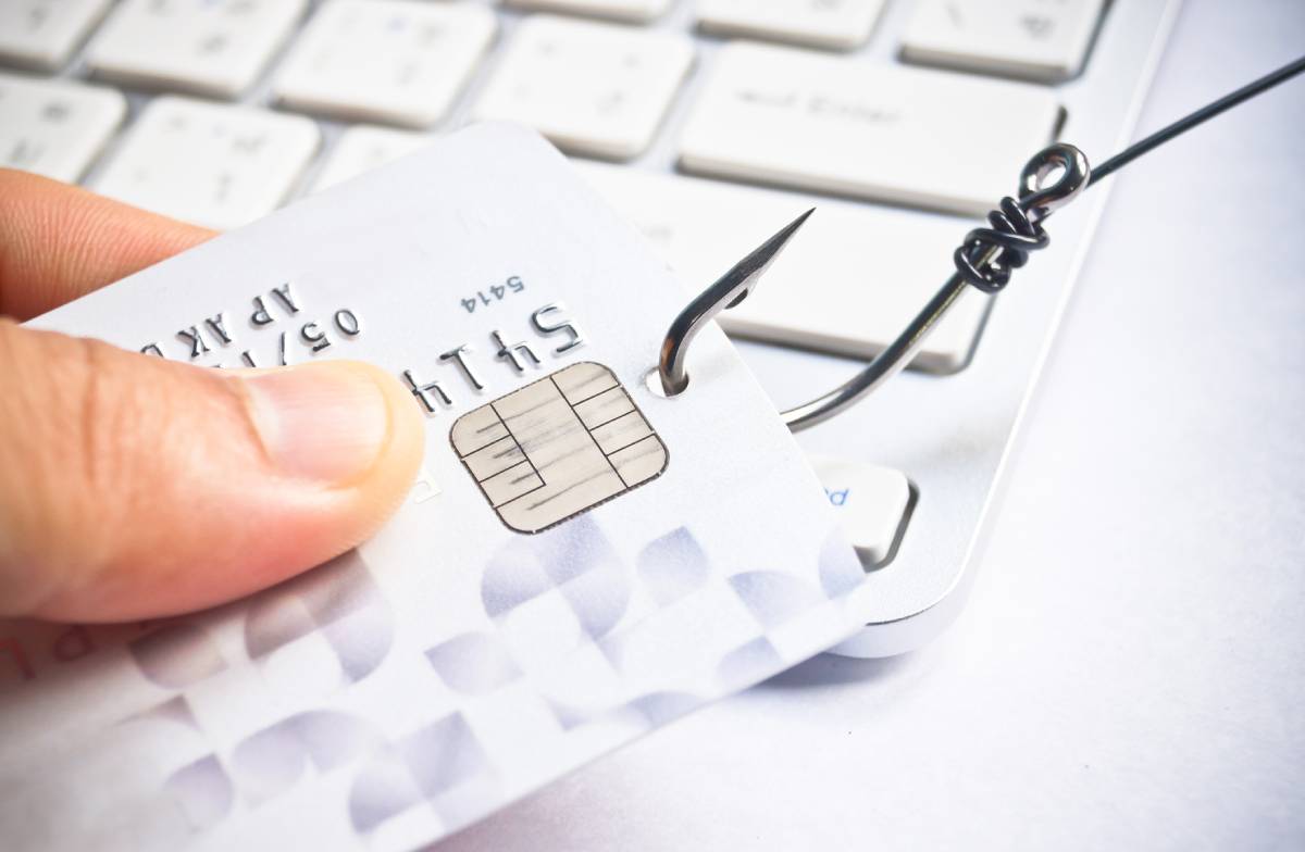 A fishhook in a credit card. Phishing concept