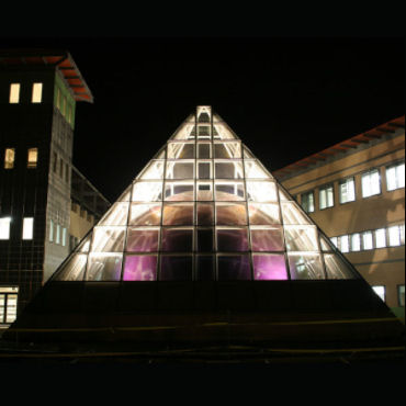 Pyramid shaped top of building, illuminated sphere inside