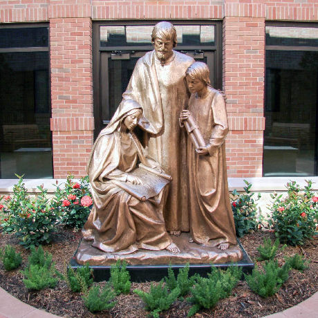 Statue of 3 figures, outside a church