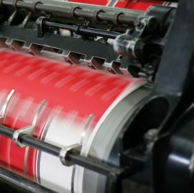 Close up of fast-moving red and white machinery