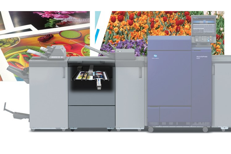 AccurioPress printing machine with colorful posters in background