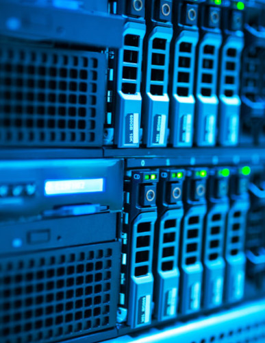 Close up of server racks, in blue lighting