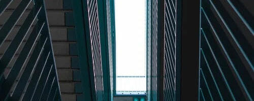 Upward view of skylight between metal railings